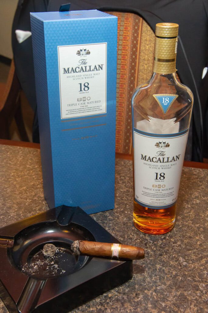A cigar and a bottle of scotch whisky