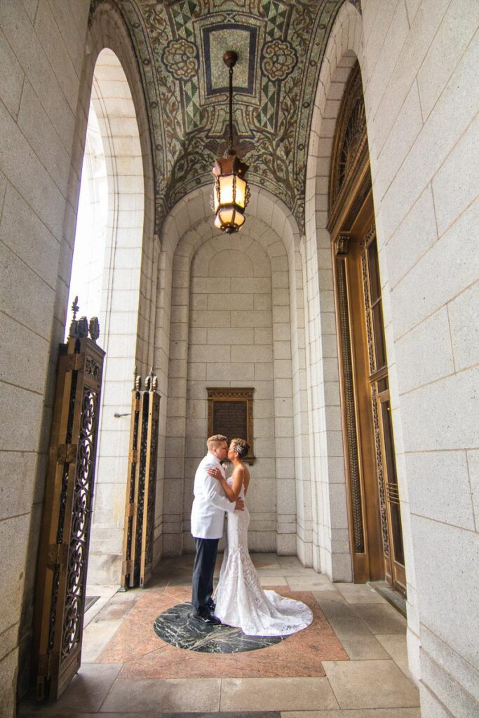 Laura and Michael kissing before the church doors