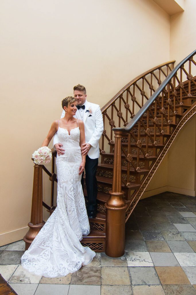 Laura and Michael at the bottom of a wooden staircase