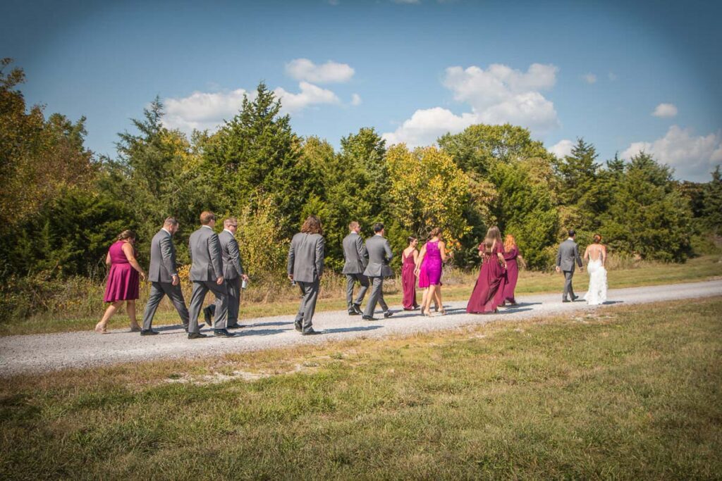 Chad and Jessie walking with their attendants