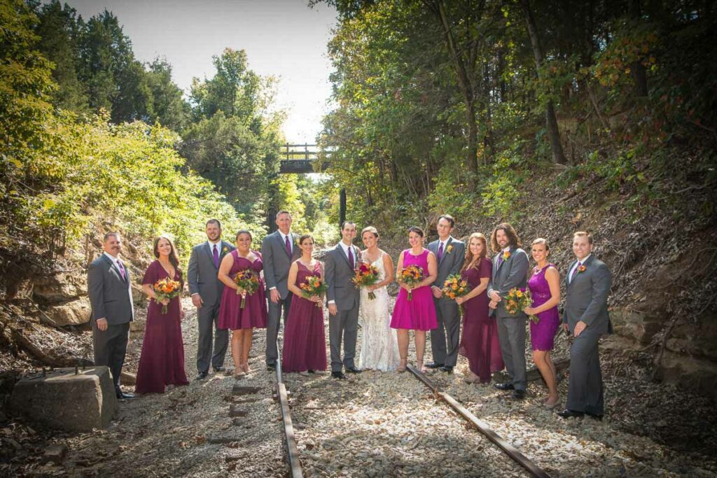 Chad and Jessie with their attendants on an old railroad