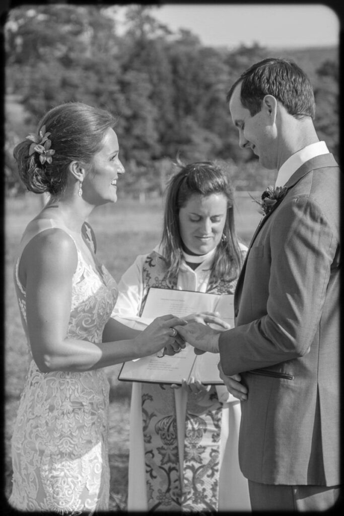 Chad and Jessie exchanging vows grayscaled