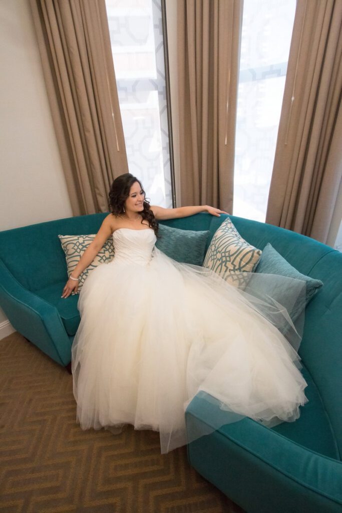 Sarah wearing her wedding dress on the couch