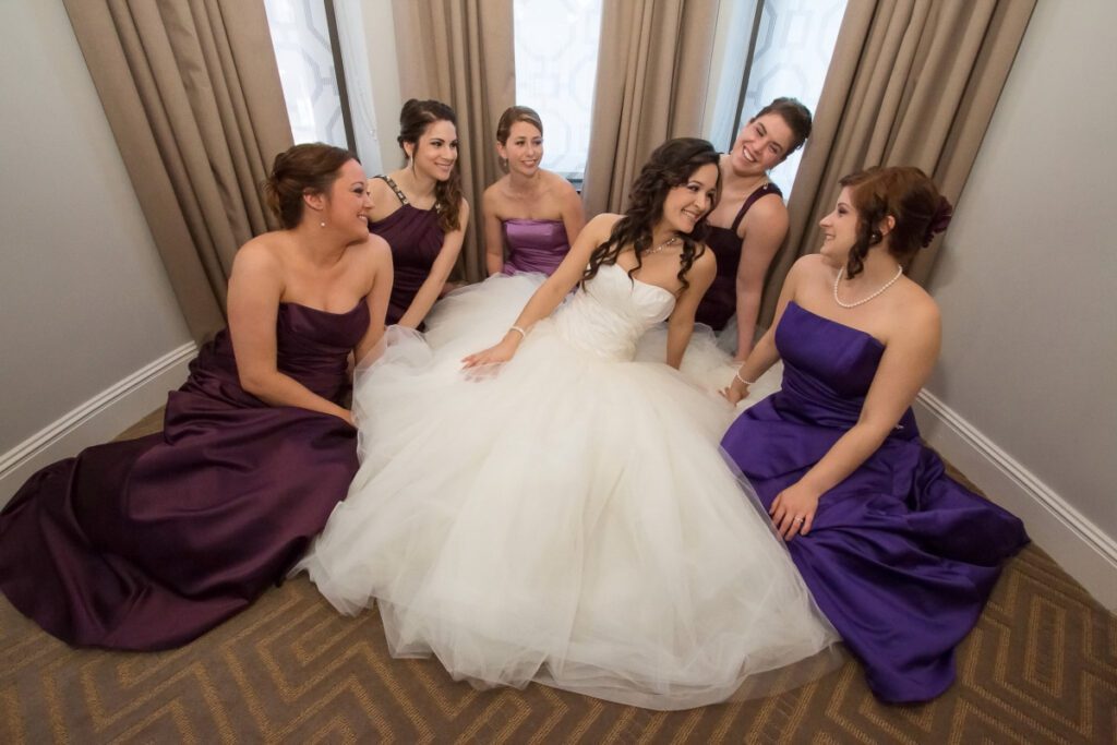 Sarah sitting on the floor with her bridesmaids