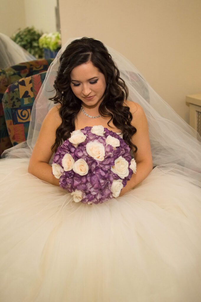 Sarah holding a bouquet of white and purple flowers