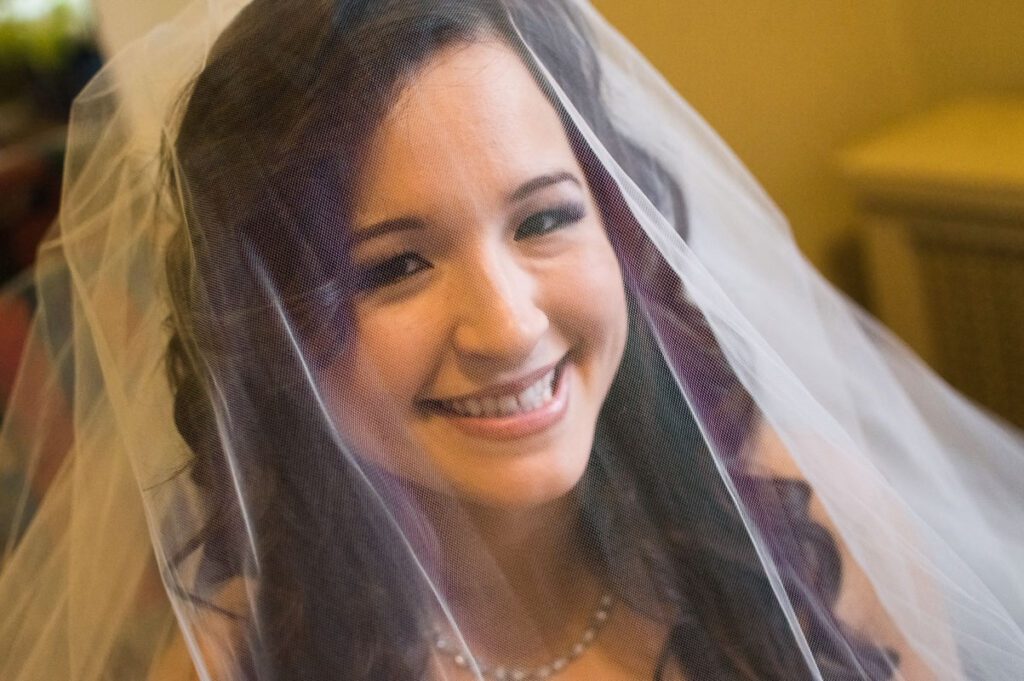 Sarah smiling under her wedding veil