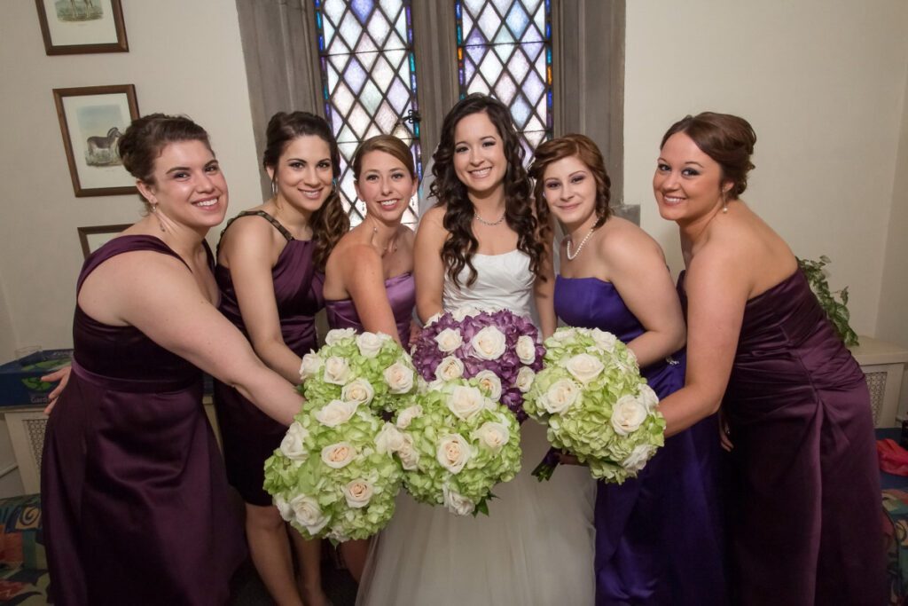 Sarah and her bridesmaids holding their bouquet of flowers