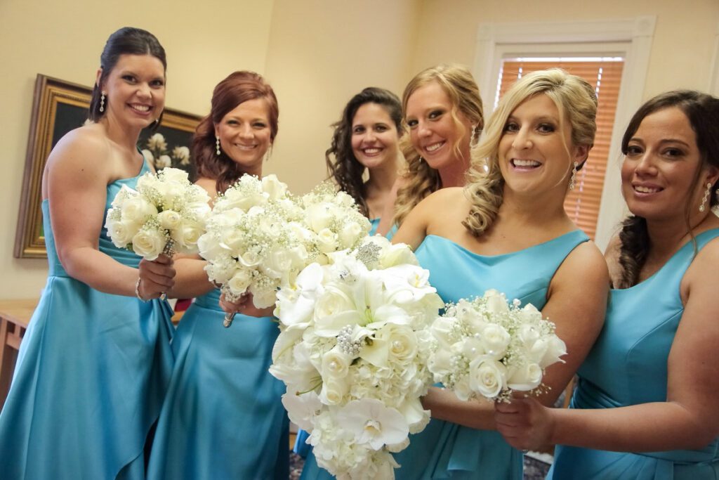 Kiley’s bridesmaids holding white flowers