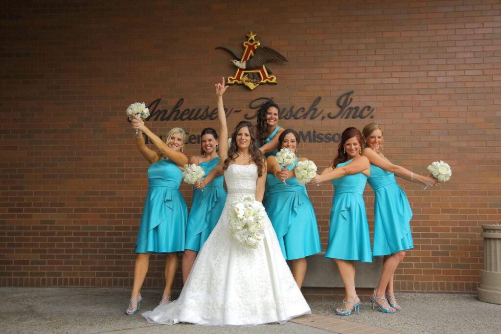 Kiley and her bridesmaids in front of a company logo