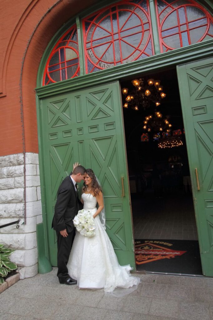 Kiley and Jason in front of green doors
