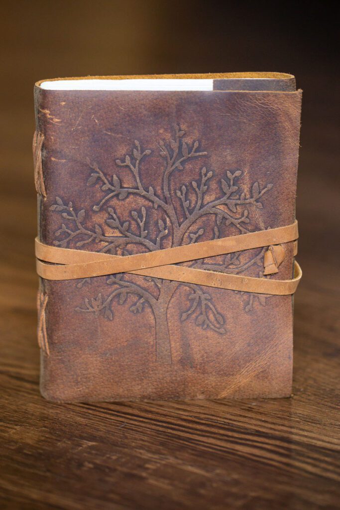 A wrapped book with a tree on the cover