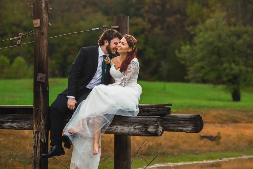 Nicole and Christian sitting on a wooden pole