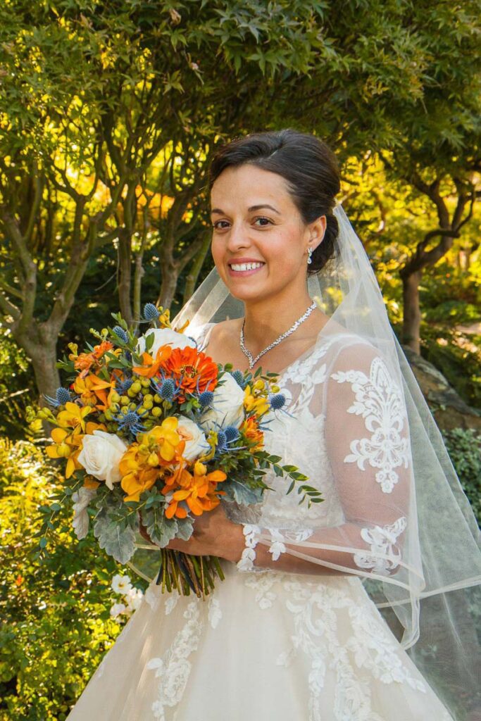 Samantha holding her bouquet close to her chest