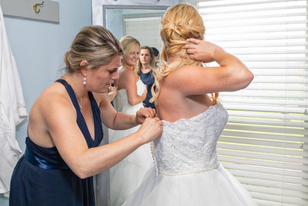 Lindsey putting on her wedding dress