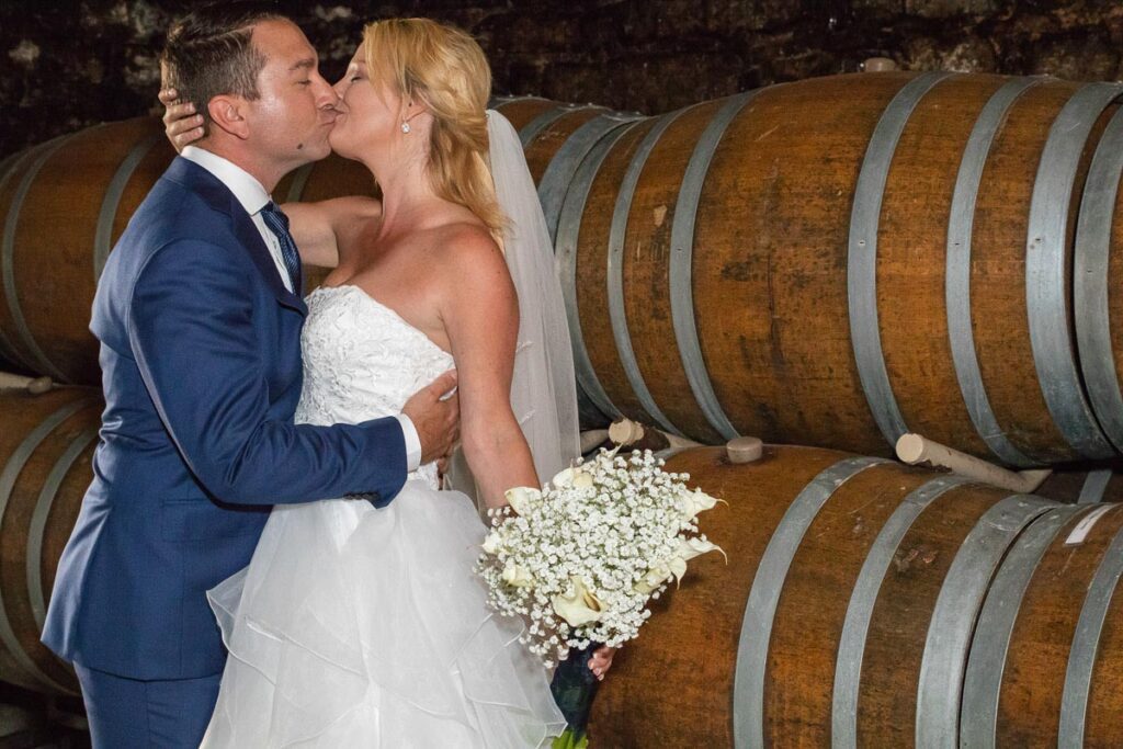 Lindsey and Zach kissing near barrels