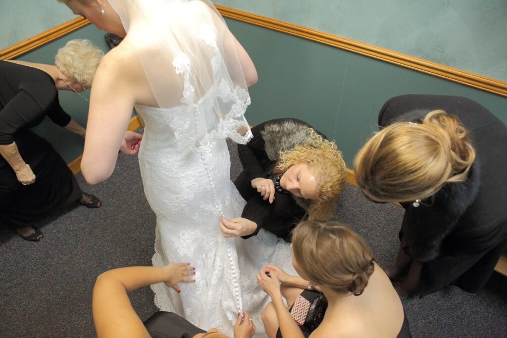 Elizabeth putting on her wedding gown