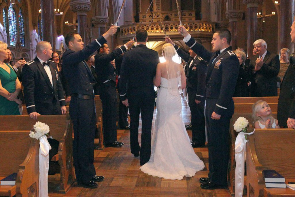 Elizabeth and Ryan pass down the aisle with salute