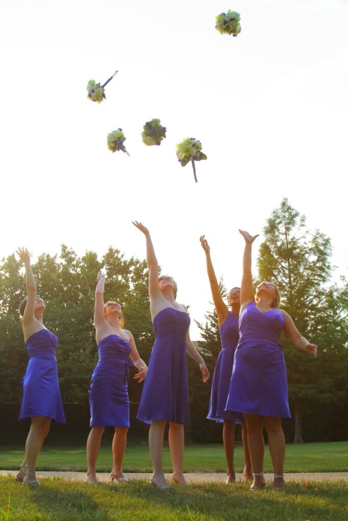 Bridesmaids throwing up their flowers