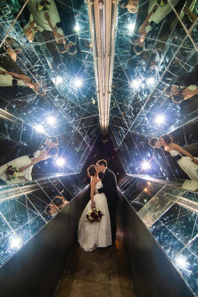 Kelsey and Nick kissing inside a mirrored hall