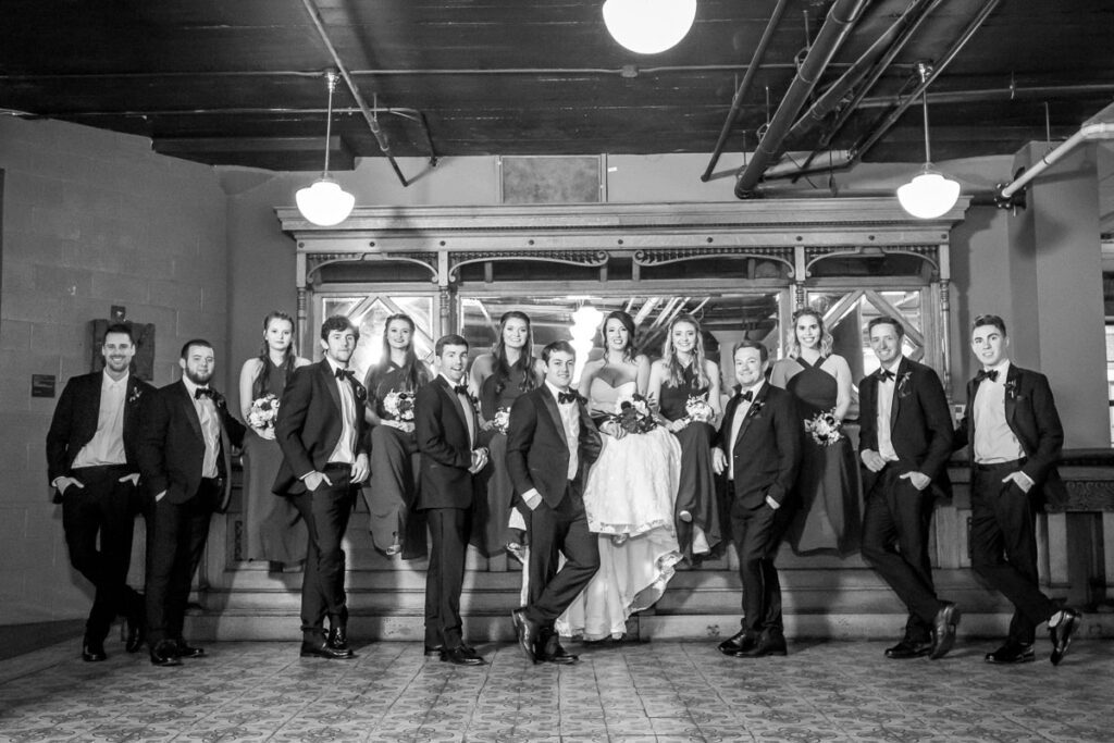 A grayscaled image of Kelsey and Nick with their attendants
