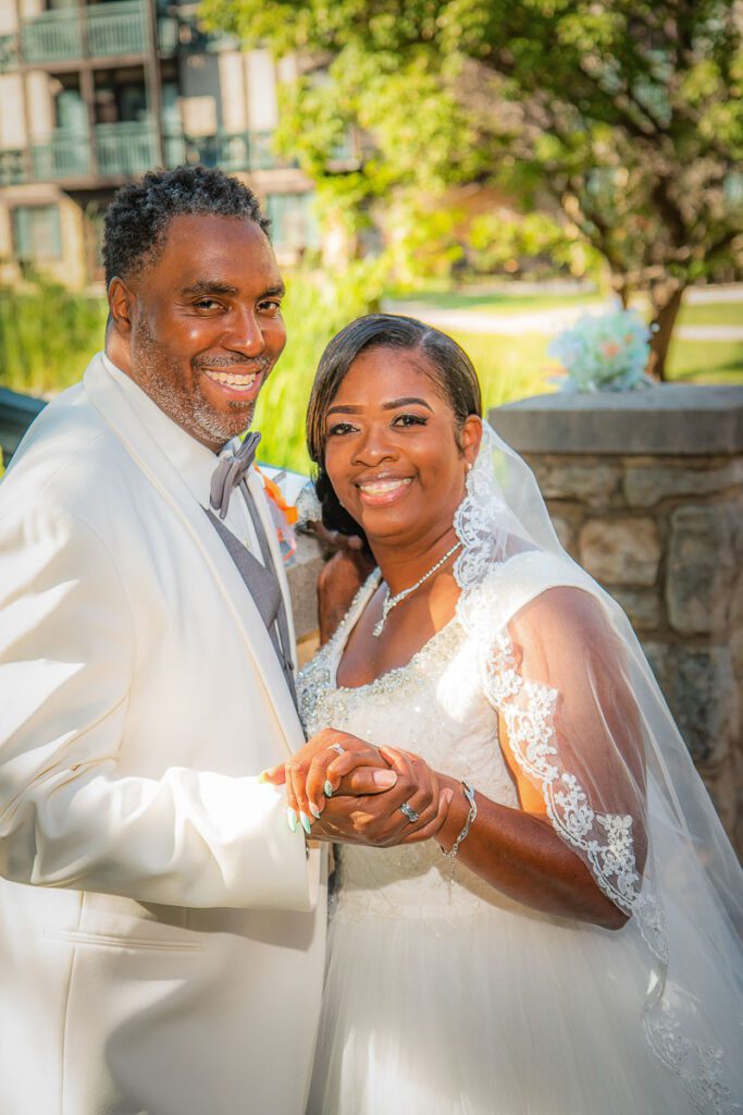 Rhonda and Tyrone smiling while holding hands