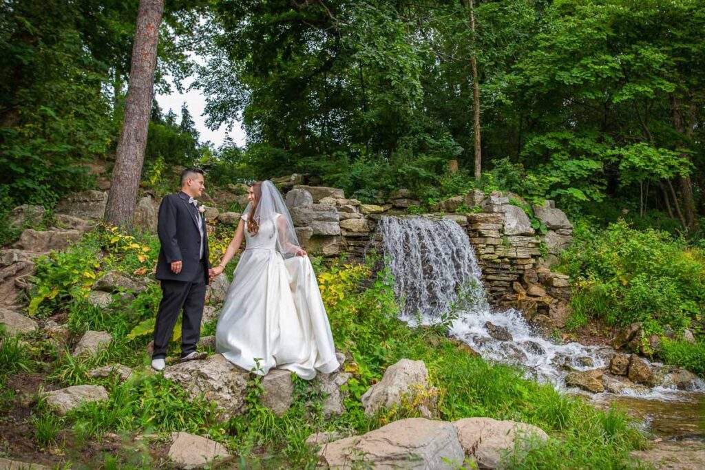 Amanda and Joe next to a waterfall feature