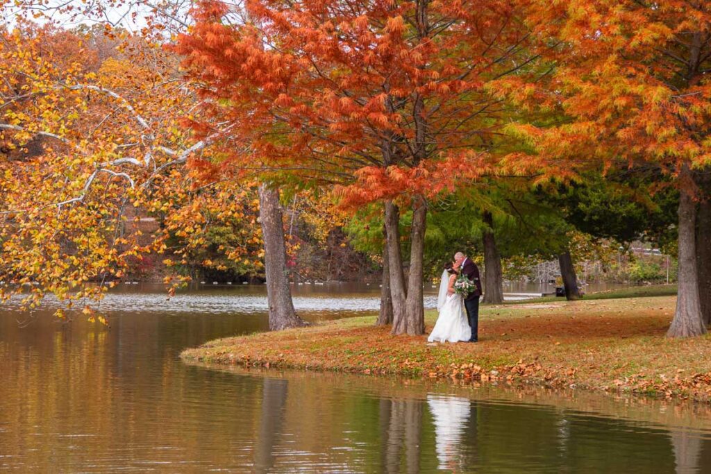 Nicole and Jason kissing under a red tree
