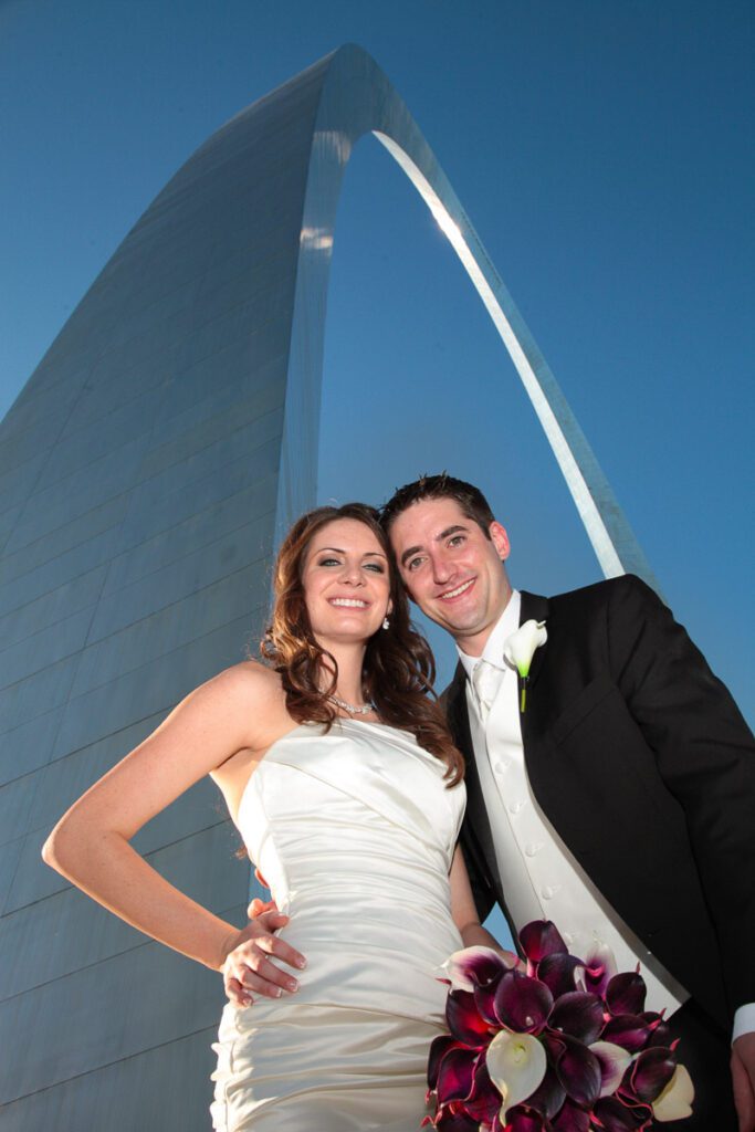 A bride and groom under the Gateway Arch