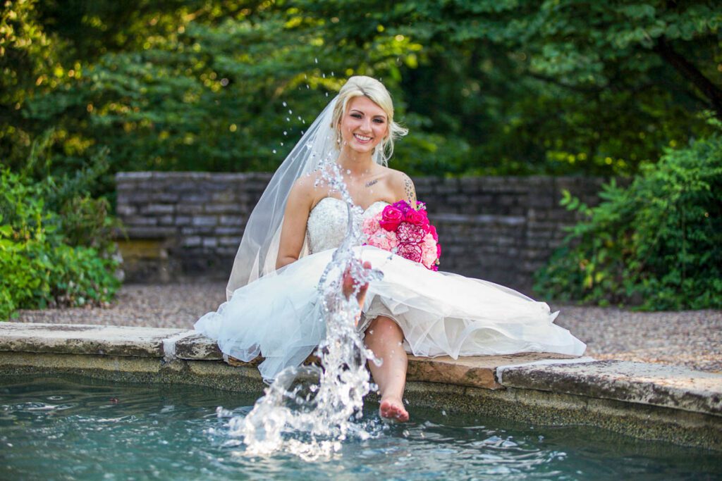 A bride splashing her feet in the water