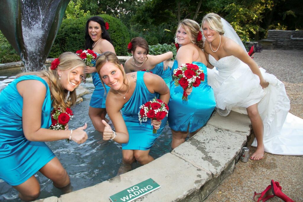 The bridesmaids wading in the fountain
