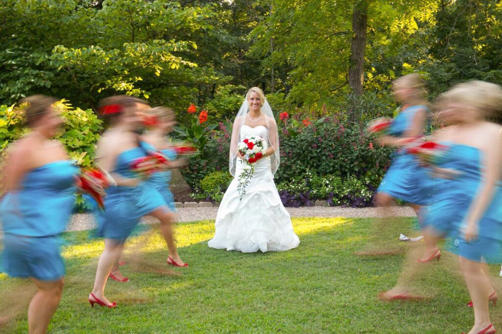 A bride at the center of her blurry bridesmaids