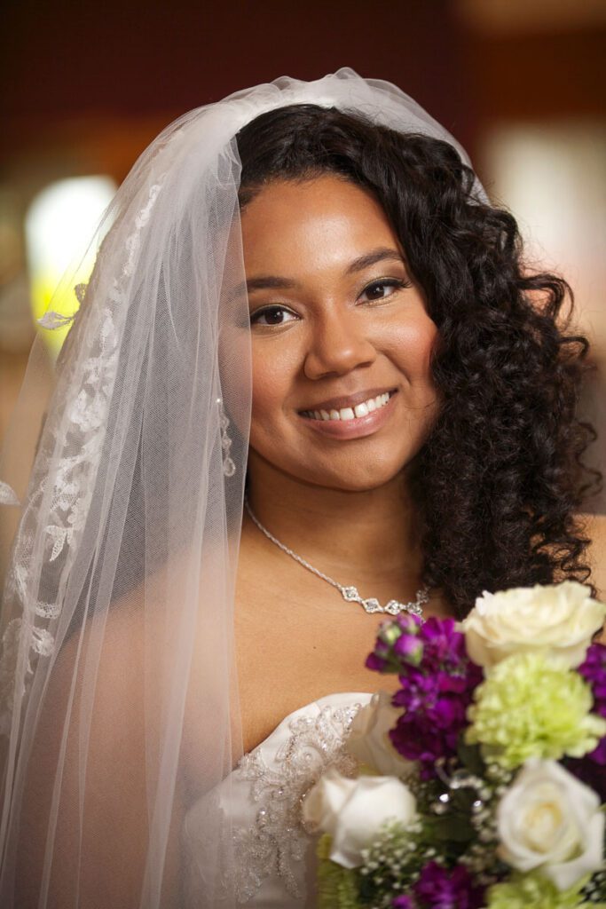 The bride smiling in her wedding dress