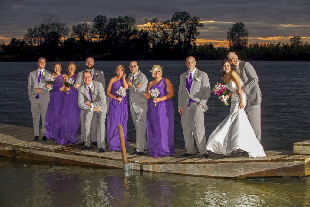 The bride and groom with their attendants on a floating pier