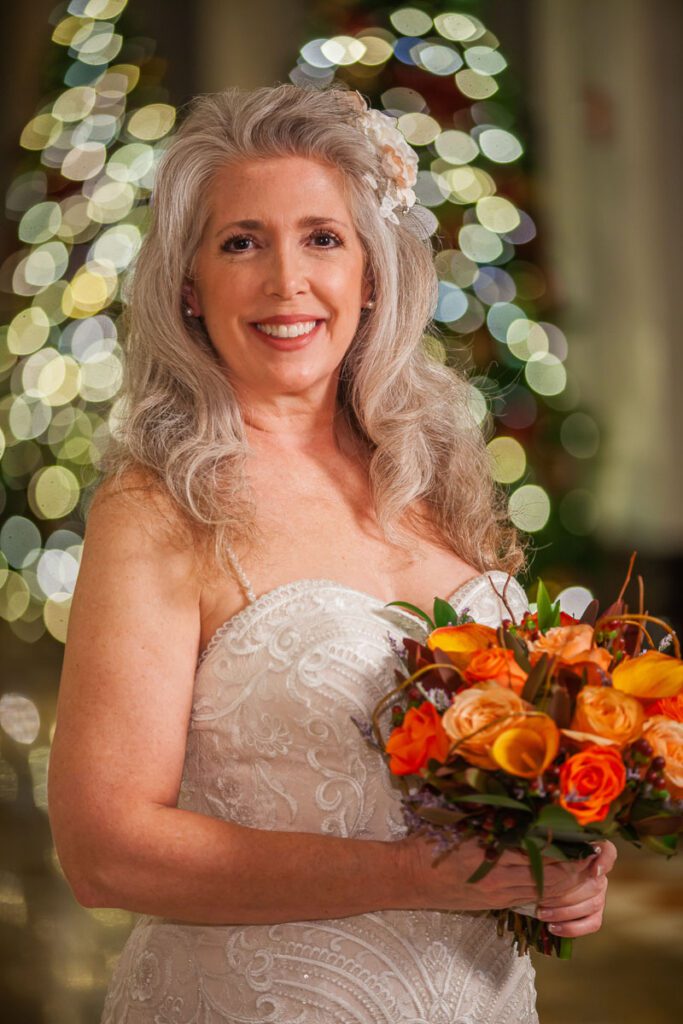 A focused portrait shot on Christie holding her bouquet