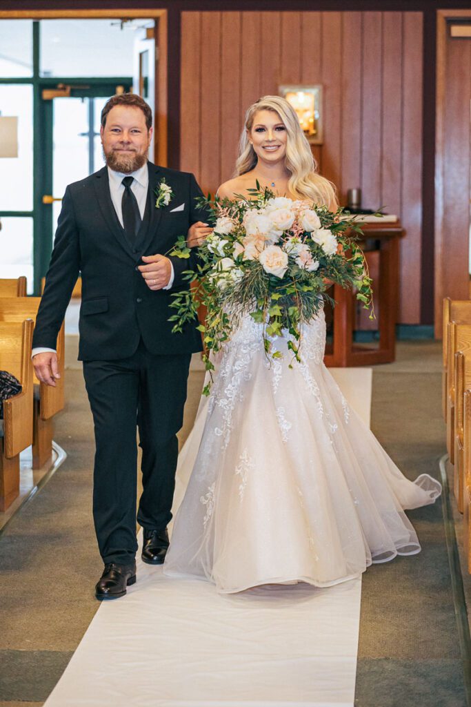 A father walking his daughter to the altar