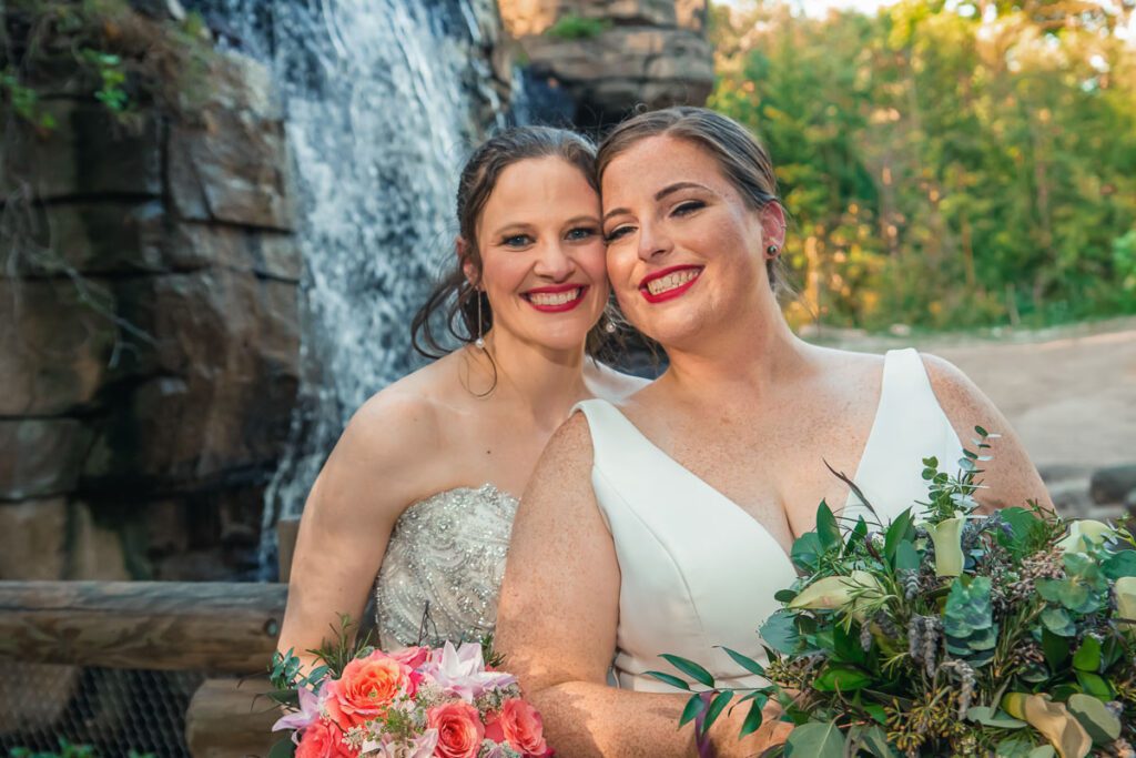 Brides smiling next to each other