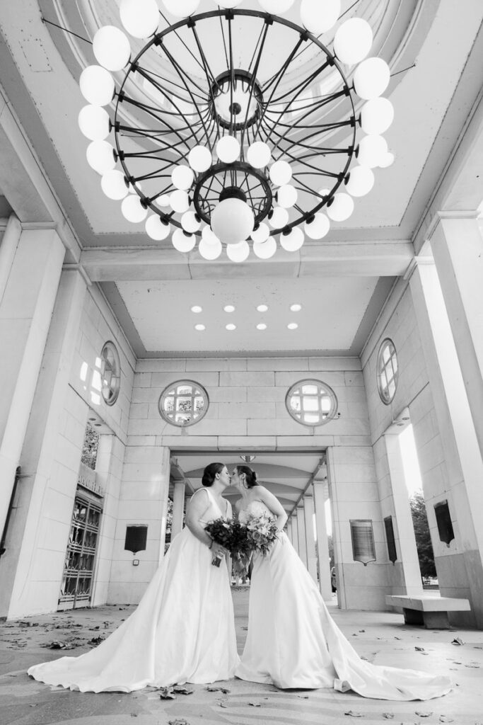 Julianne and Annie kissing under a large chandelier