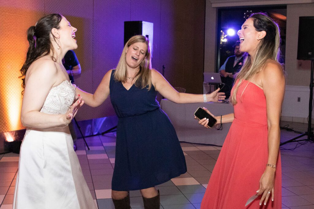 One of the brides singing with friends