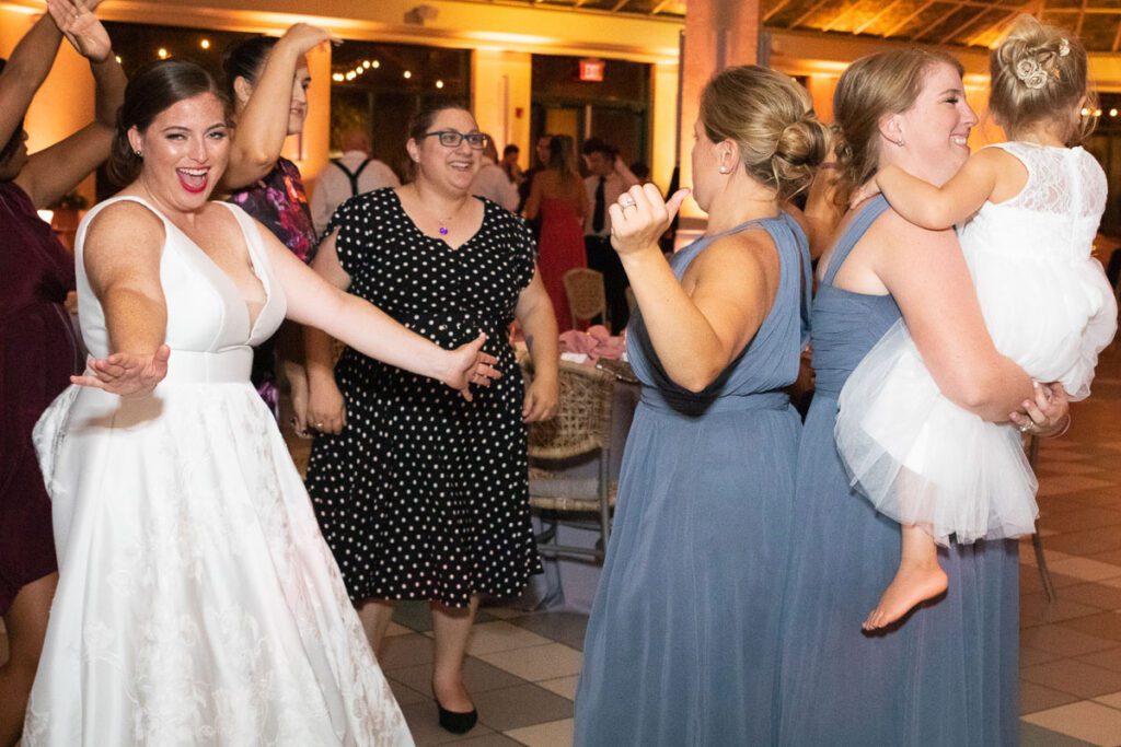 One of the brides dancing with their friends