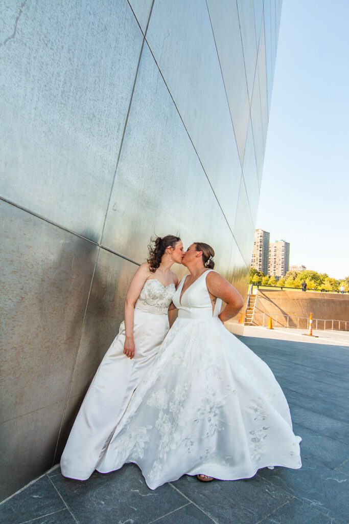 The brides kissing at the Gateway Arch sweetly