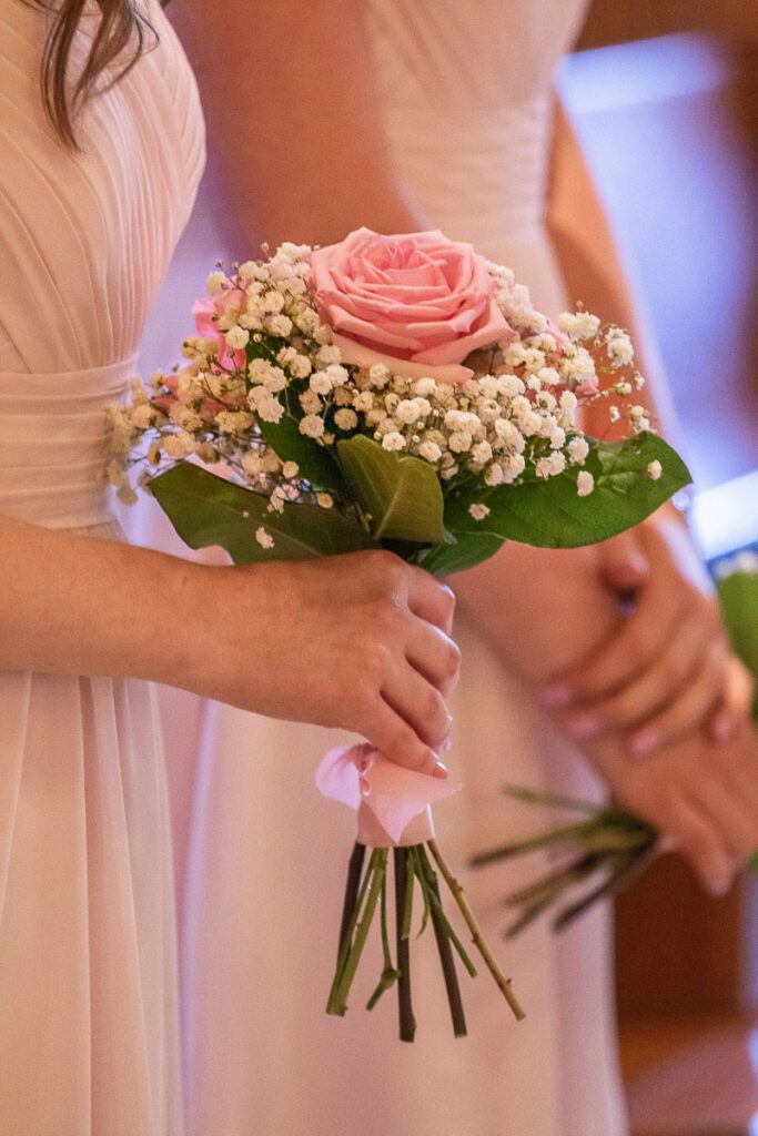 A bridesmaid holding flowers