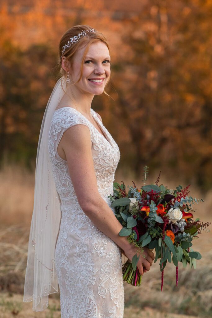 The bride smiling while holding her flowers