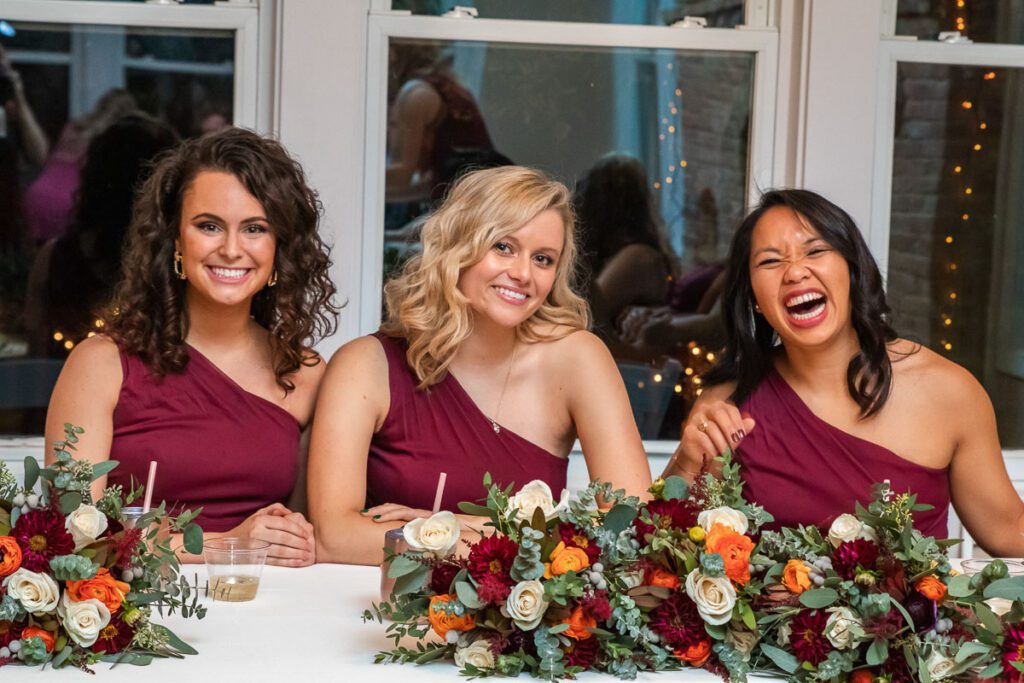Bridesmaids happily sitting at the table