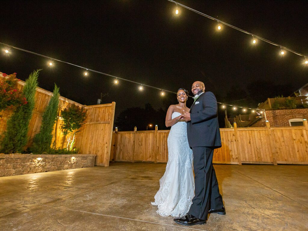 Michelle and Malcolm dancing under lights at night