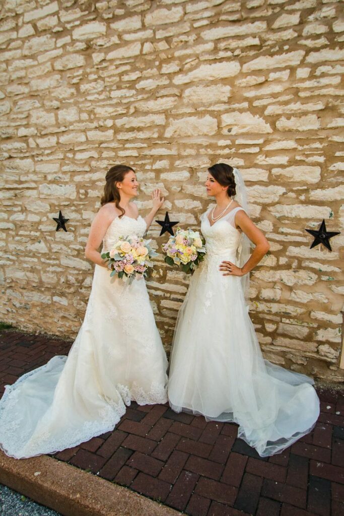 Two brides next to a wall with stars