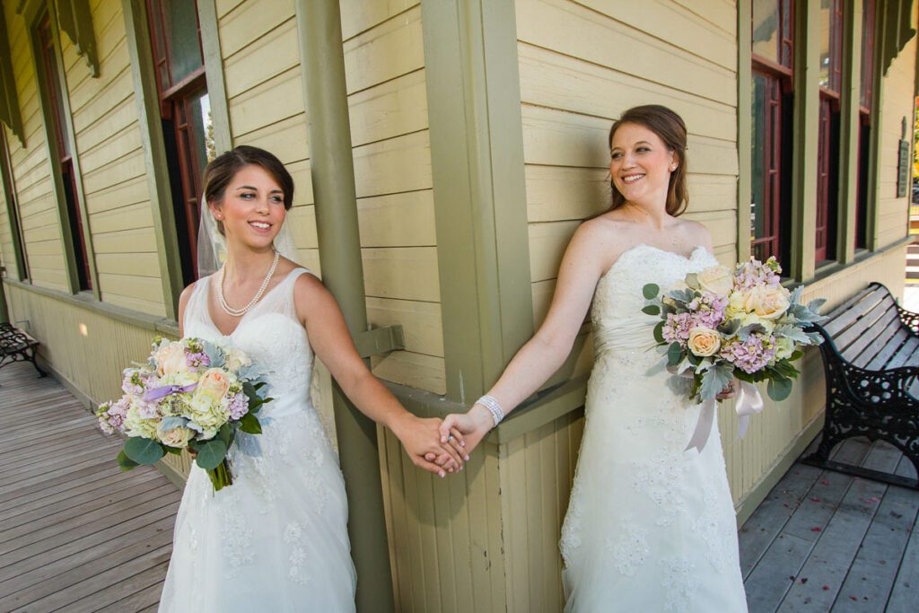 Two brides holding hands