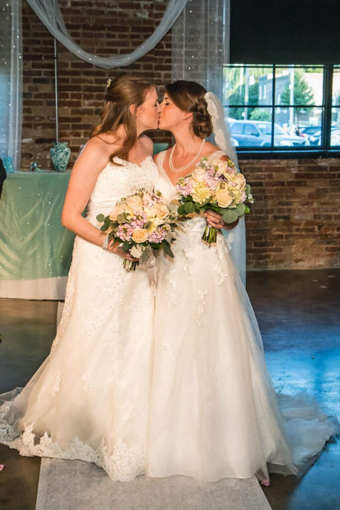 Nicole and Shaina kissing each other at the altar
