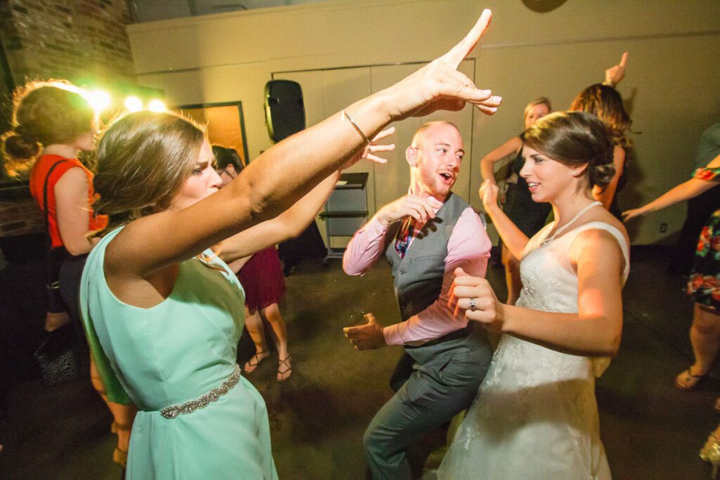 One of the brides dancing with her friends