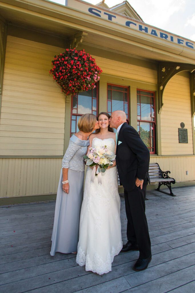 A bride kissed by her parents