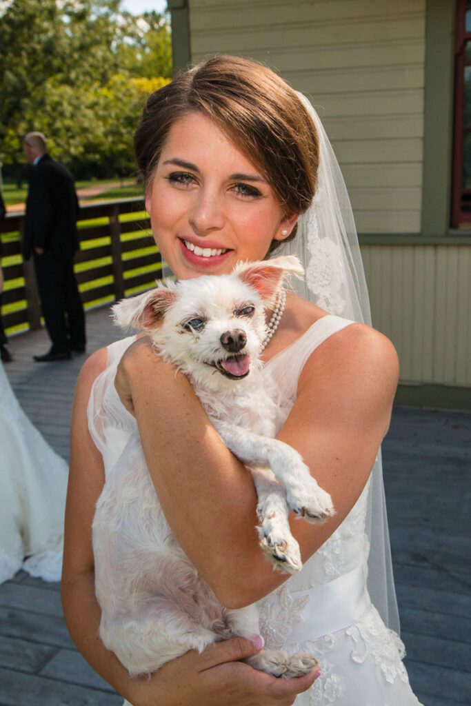 A bride holding a dog